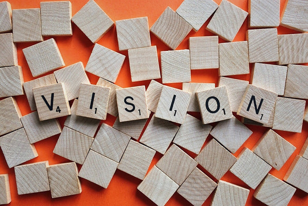 A set of scrabble tiles forming the word vision