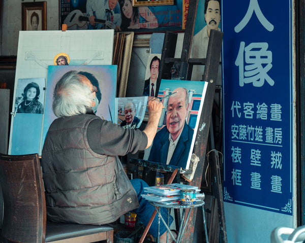 An elderly man doing portrait painting
