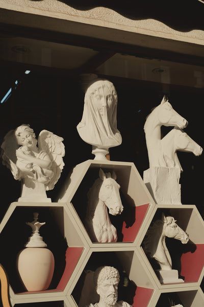 White molds of animals in a shelf