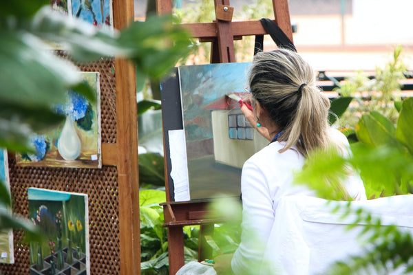 Woman painting outside garden