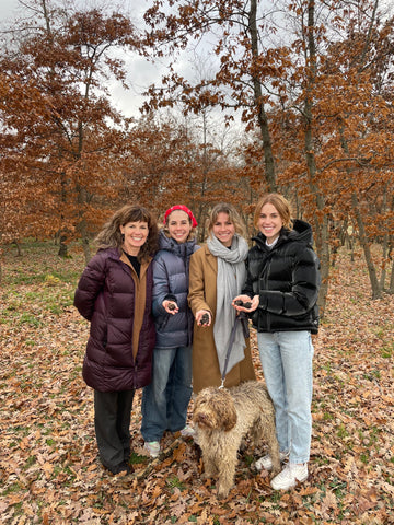 Four women in the forest with a truffle-hunting dog