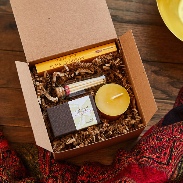 Gift box including The Pocket Pema Chodron book, a glass vial of matches and beeswax votive, a small box of Tangle Chocolate slivers