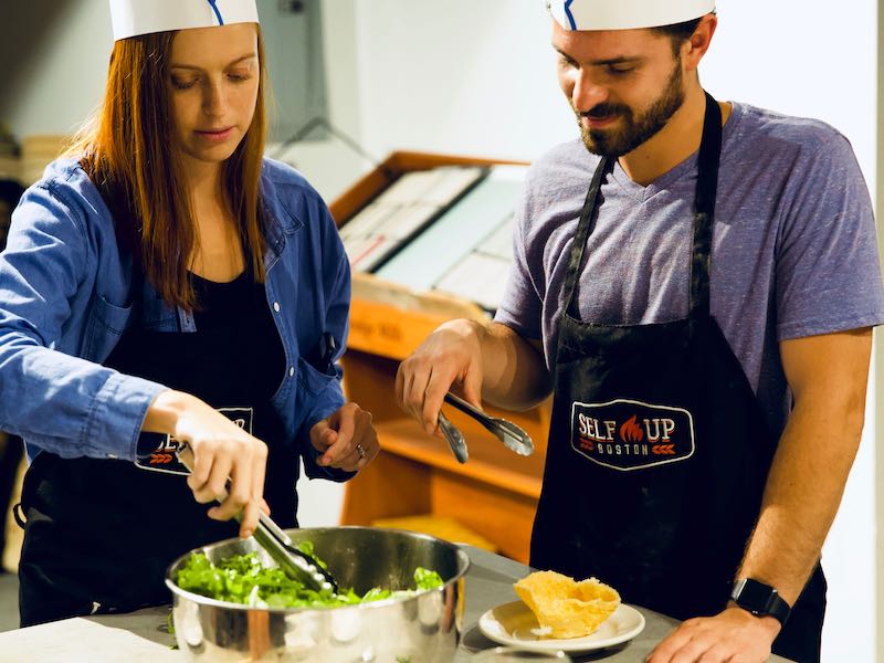 Gifting a Couples Cooking Class | A couple cooking salad