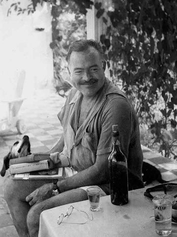 Hemingway smiling with drink