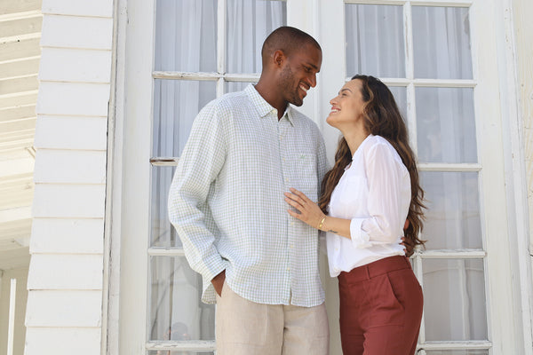 Man and woman look lovingly at one another on tropical island