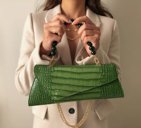 Model holding an Aliel handbag