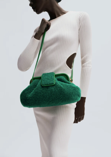 Model wearing Maven shearling women’s handbag in green.