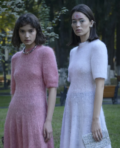 Models wearing pink and white dress