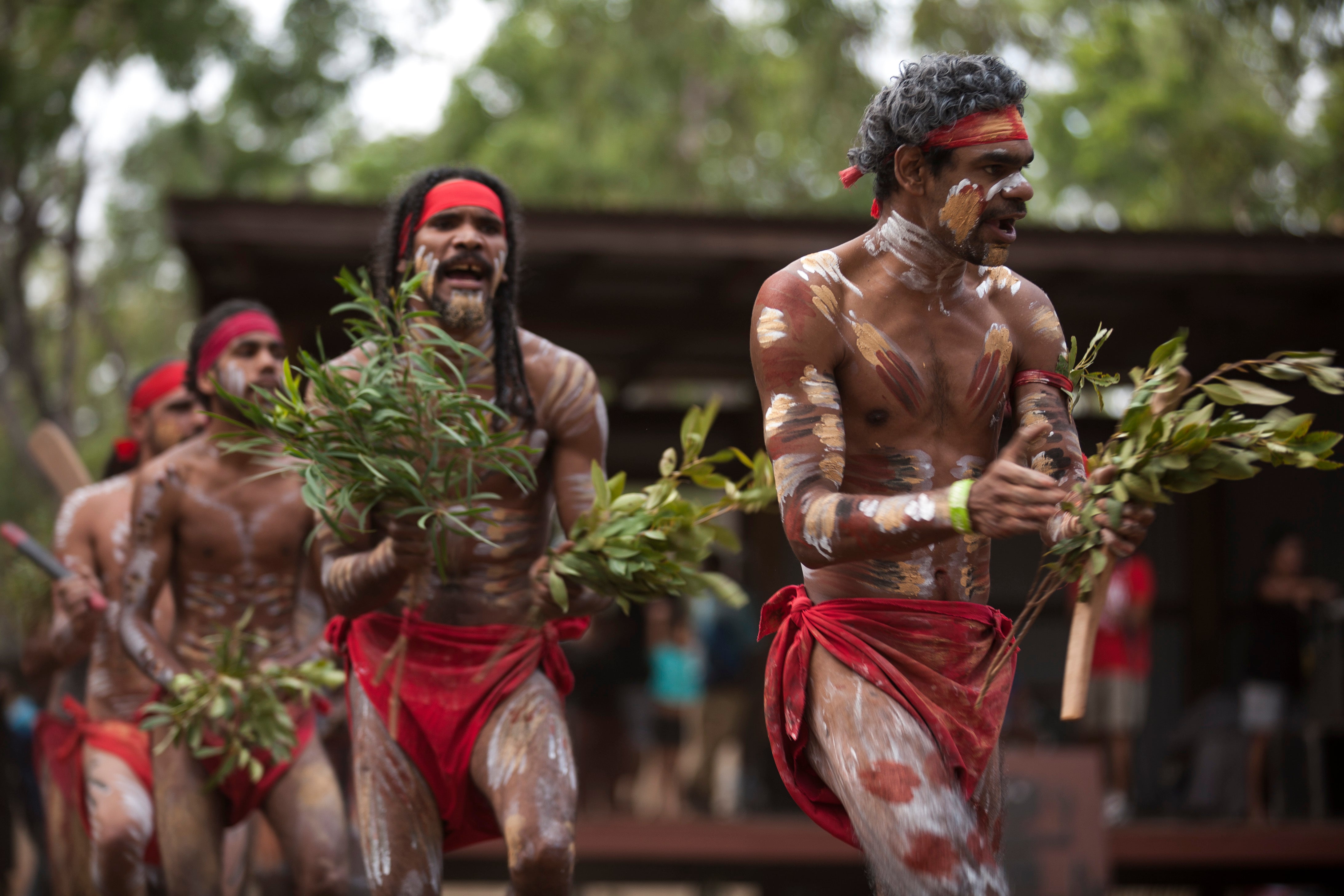 Girls decorated for a ceremonial, red and white face paint