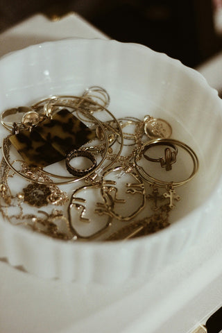 Gold Jewelry in White Bowl