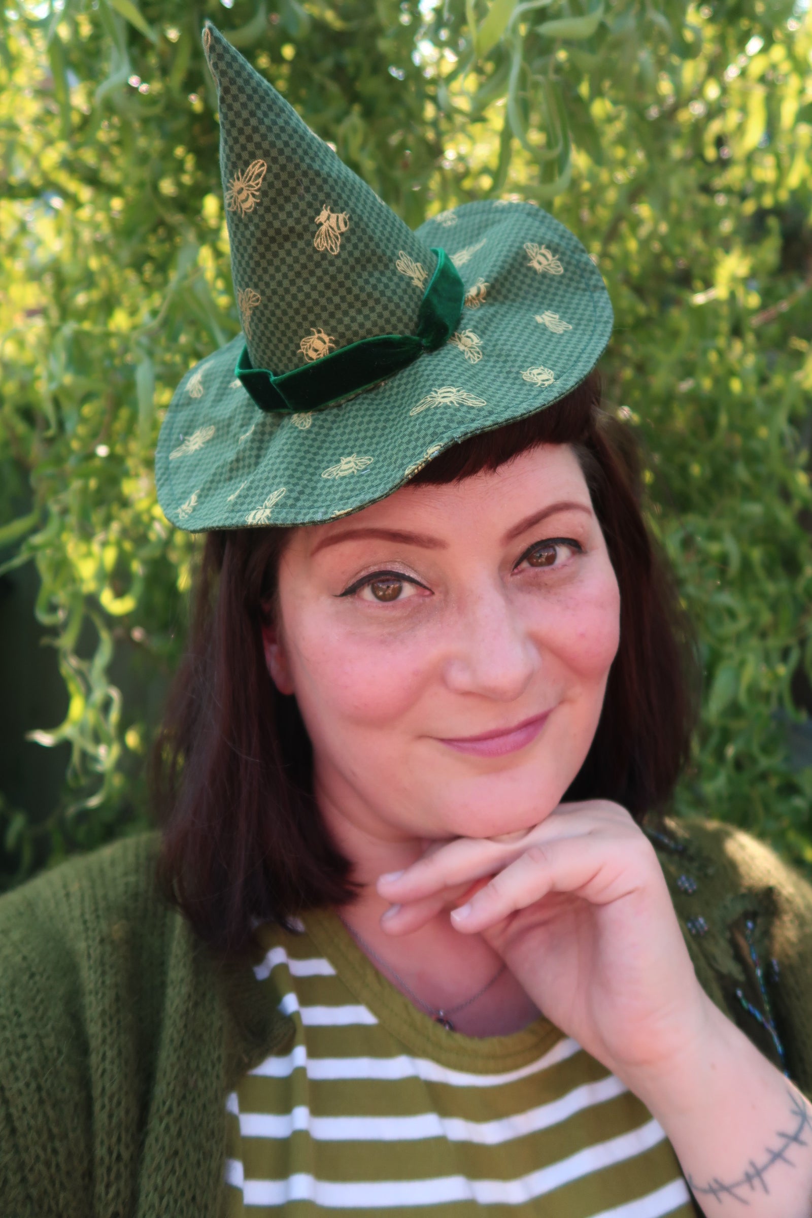 Woman wears green woodland vintage witch hat in woodland 