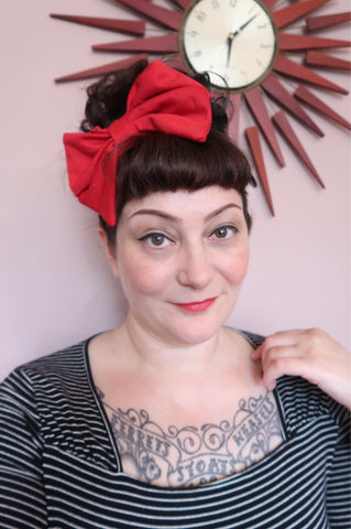 Woman wearing red vintage hair bow