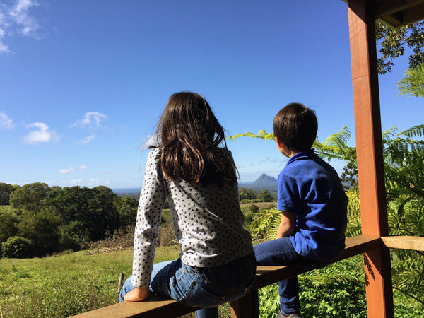 kids looking out at four cow farm