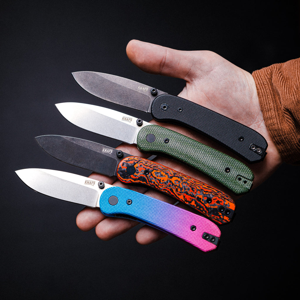 hand holding 4 knafs lander knives with different handle materials