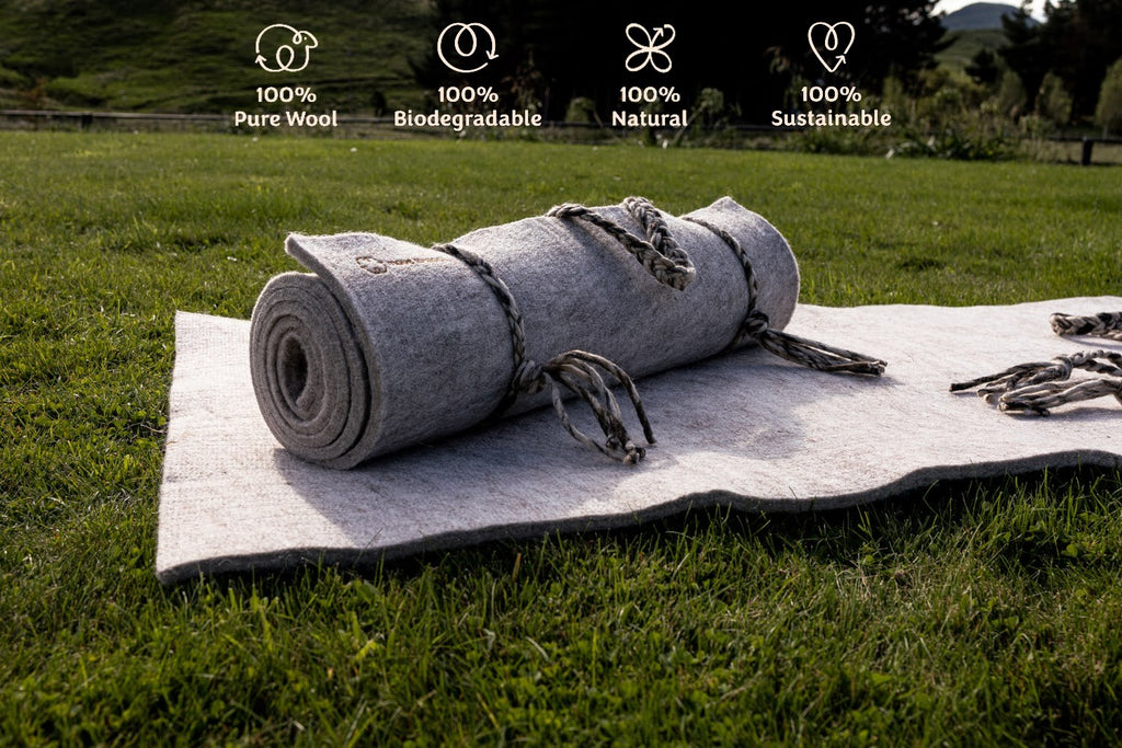 Move to Wool Movement Mats - one lying on grass in paddock with one rolled on top + Move to Wool icon logos | Eco Yoga Store