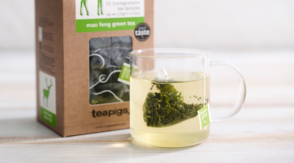 a image of some teapigs mao feng green tea in a glass tea cup