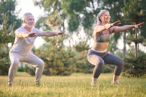Healthy Seniors do yoga outside because they take supplements for joint health 