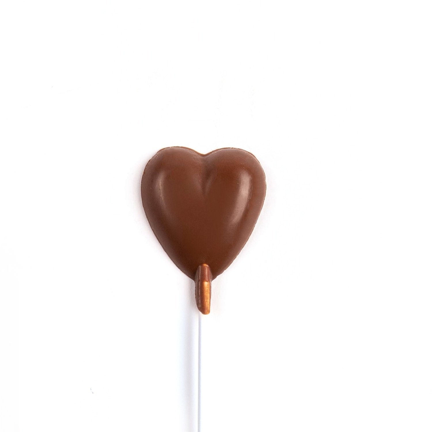 Image of milk chocolate heart on a stick.