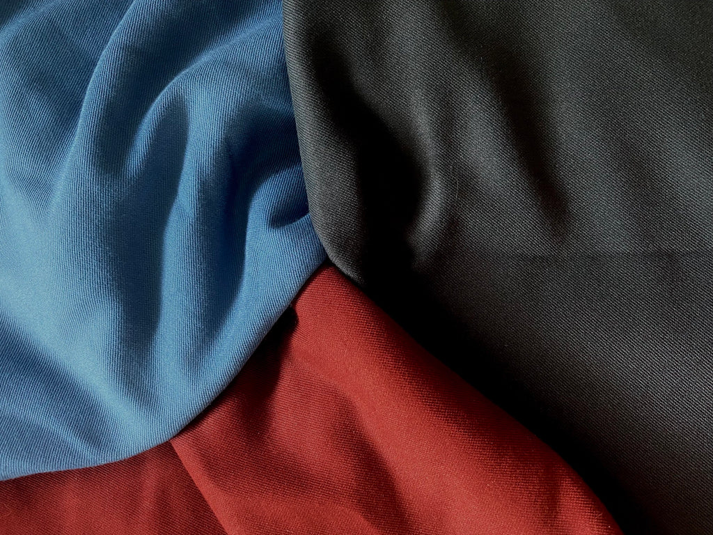 A blue, red, and dark grey material. 