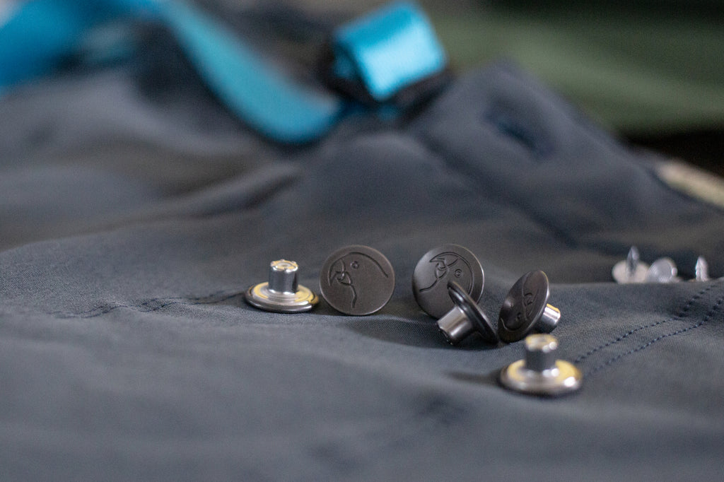 The detailed buttons of the pants. 