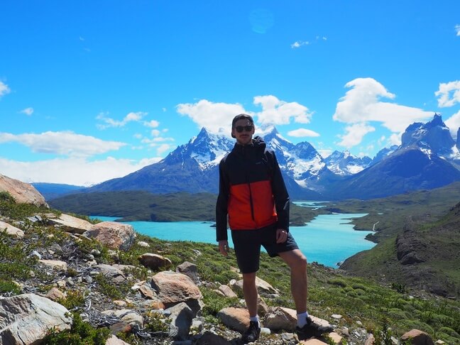 Tom in Patagonia 2017, with mountains and a turquoise lake in the background