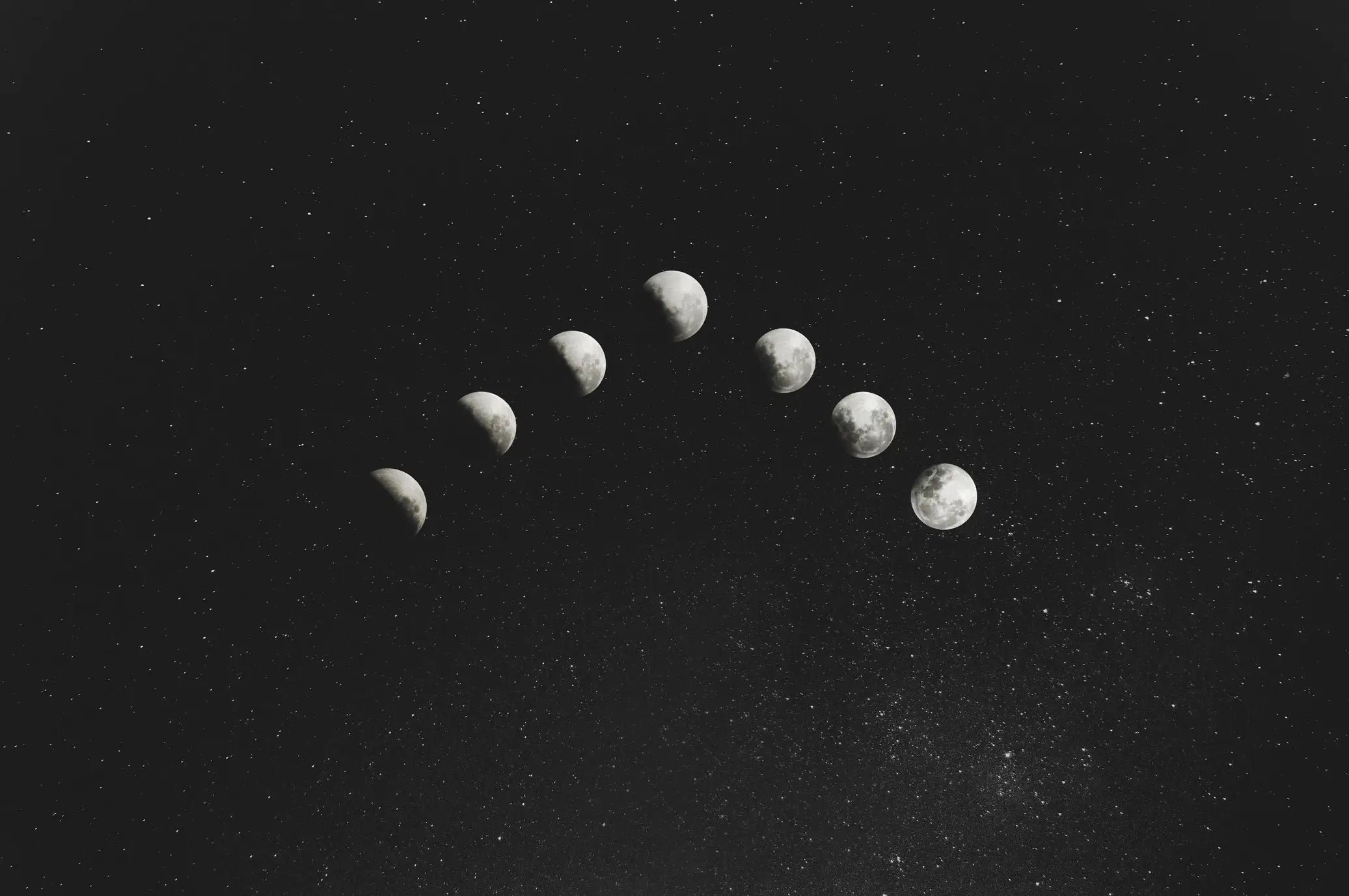 A dark, starry sky showing the phases of the moon