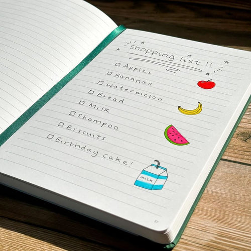 A shopping list in a journal with fruit doodles