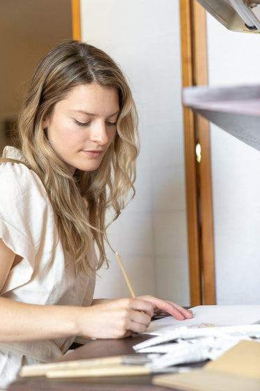 A woman writing at a desk