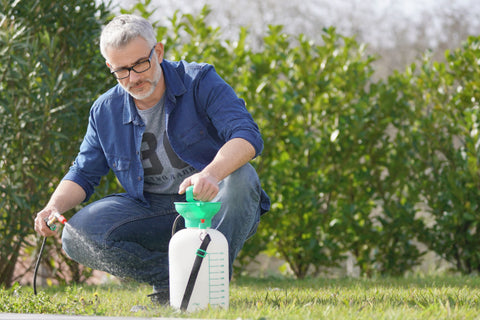 man spraying yard