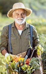 Papa Zeep holding a basket full of vegetables