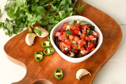 Salsa in bowl with ingredients