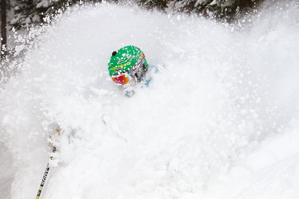 A skier is deep in powder.