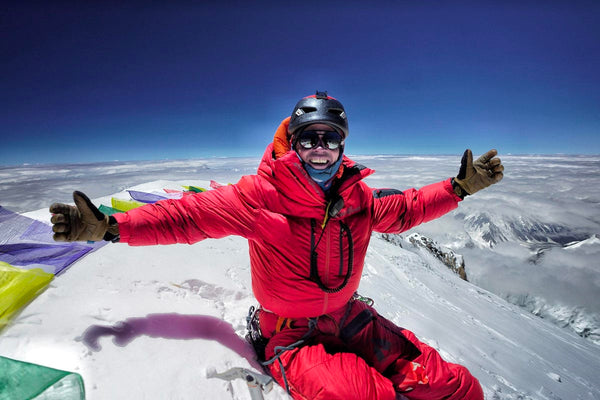 Adrian Ballinger sits on the top of Mount Everest