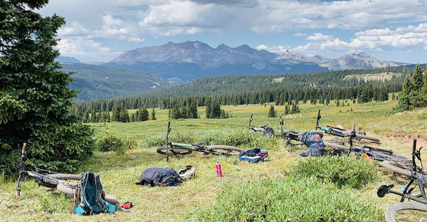 Bikes lie on the grass in a mountain range