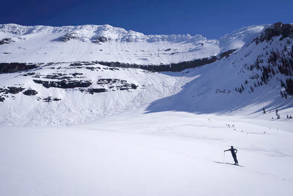 A small skier contemplates big terrain.