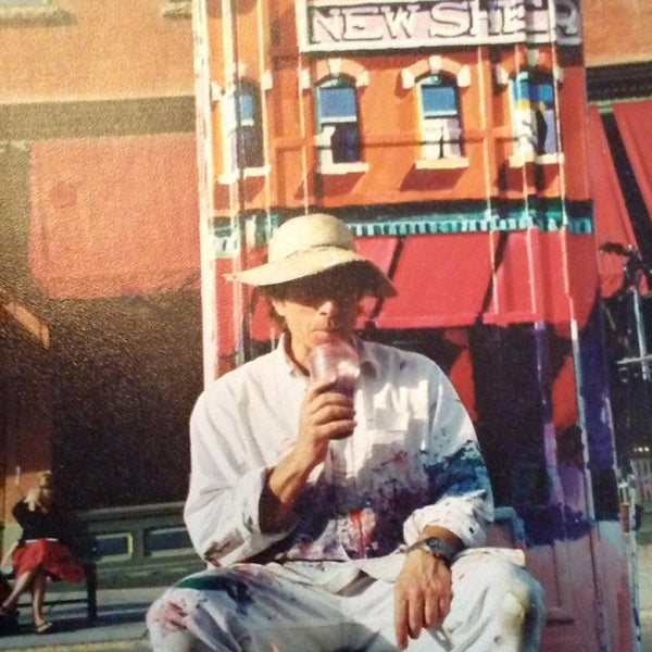 Roger Mason takes a break while painting the iconic phone booth in Telluride, Colorado.