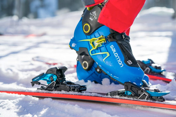 A person steps into their ski binding