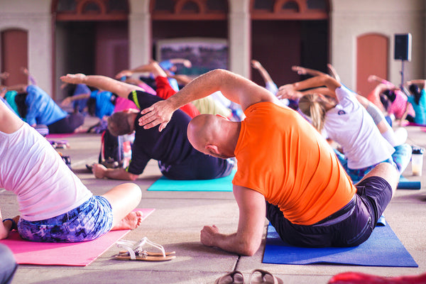 A group of people practice yoga