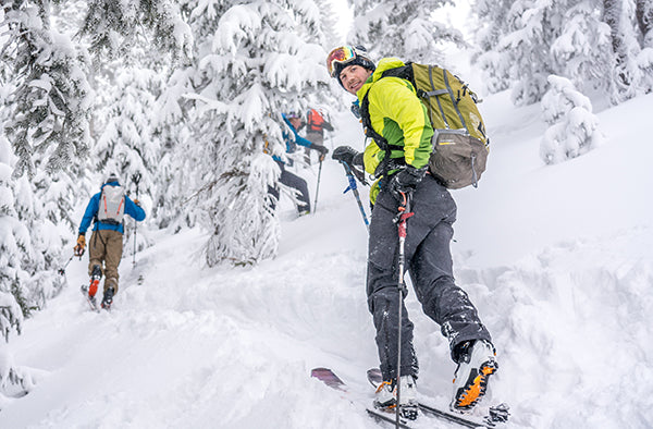 A skier skins uphill.