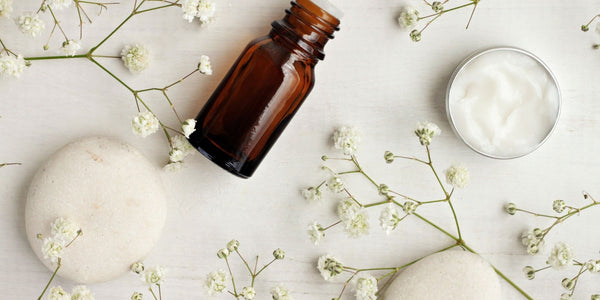 natural skincare ingredients in a dropper bottle and cream