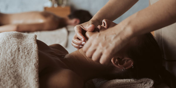 Woman receiving facial massage at the spa.