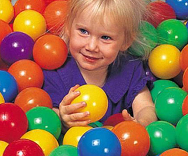 a girl playing on a indoor jumpy house