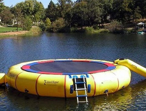 yellow water trampoline setted up in a park