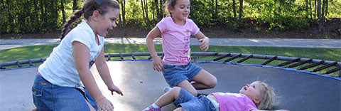 multiple kids having fun on large trampoline