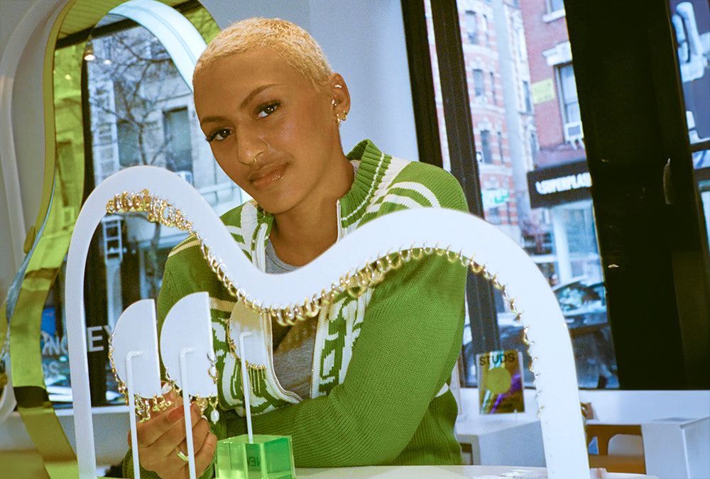 Image of a person at a counter shopping for earrings.