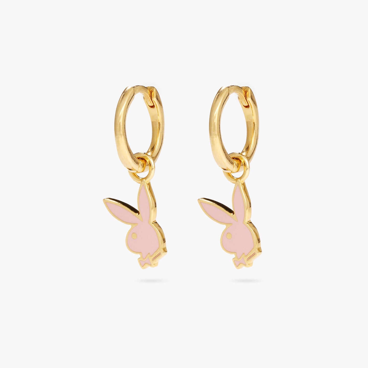 A pair of gold huggies with enamel pink playboy bunny charms [pair] color:null|gold/pink