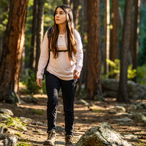 Woman wearing Vapor Apparel walking in forest