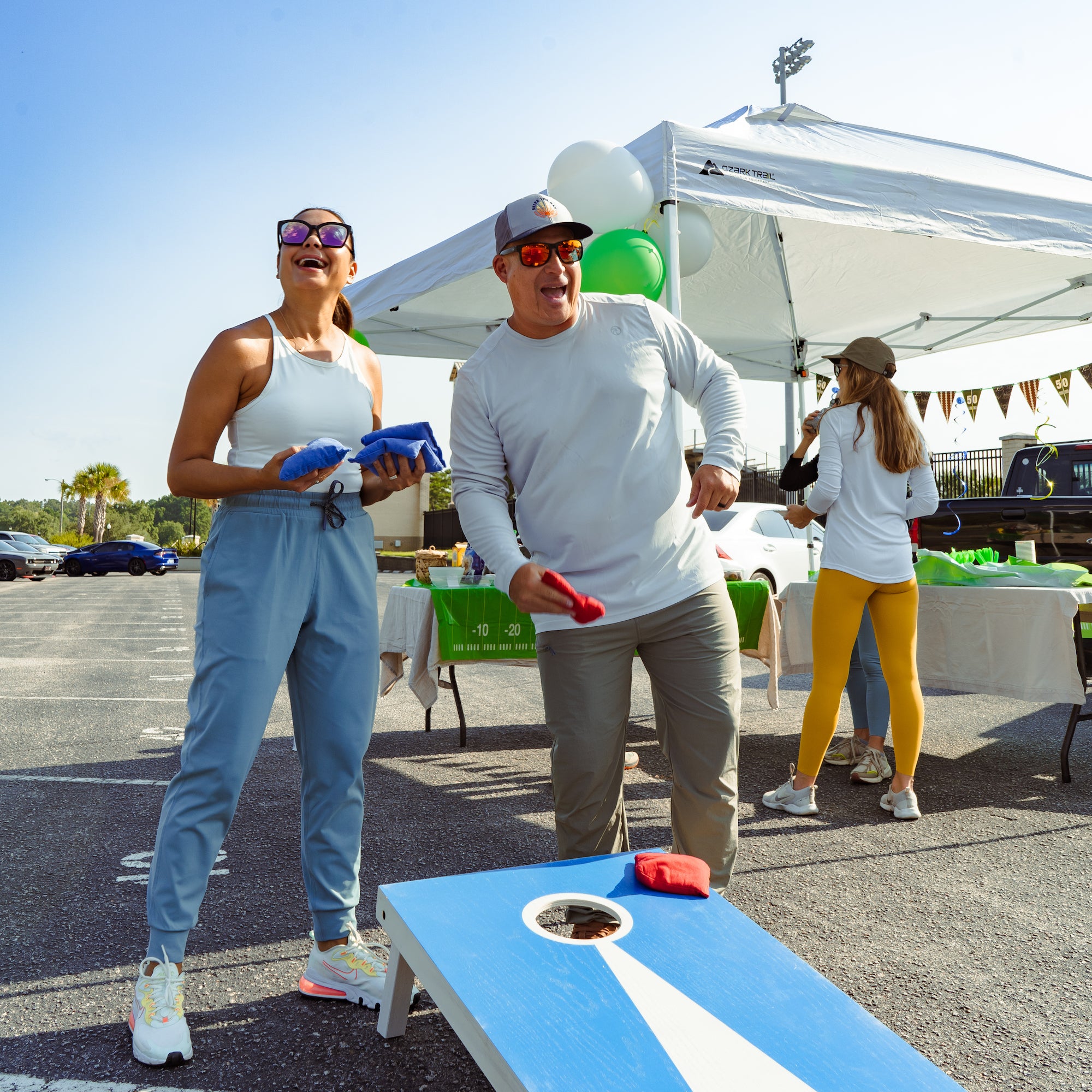 Man and woman playing corn hole