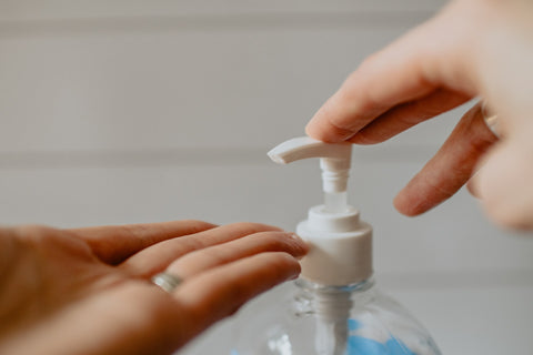 Person pressing sanitizer out of the bottle