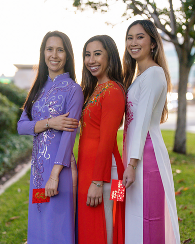 3 women wearing Vietnamese áo dài dress